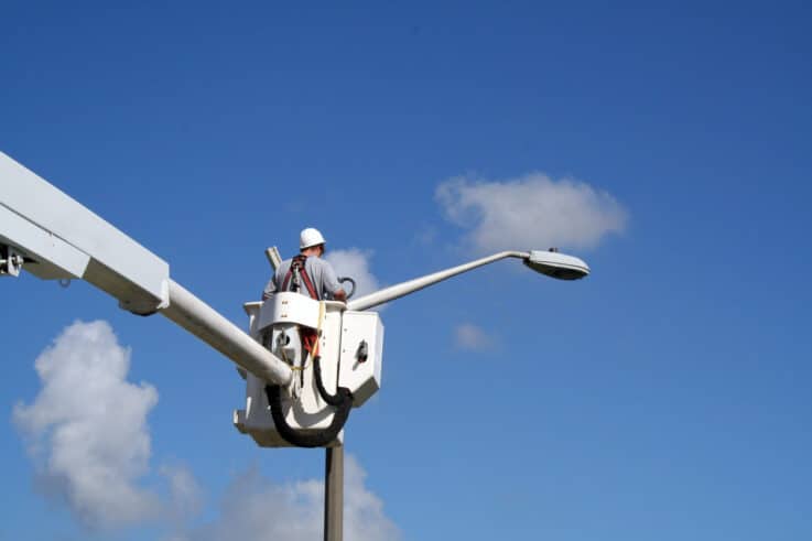 Utility worker installing a close-circuit video camera.